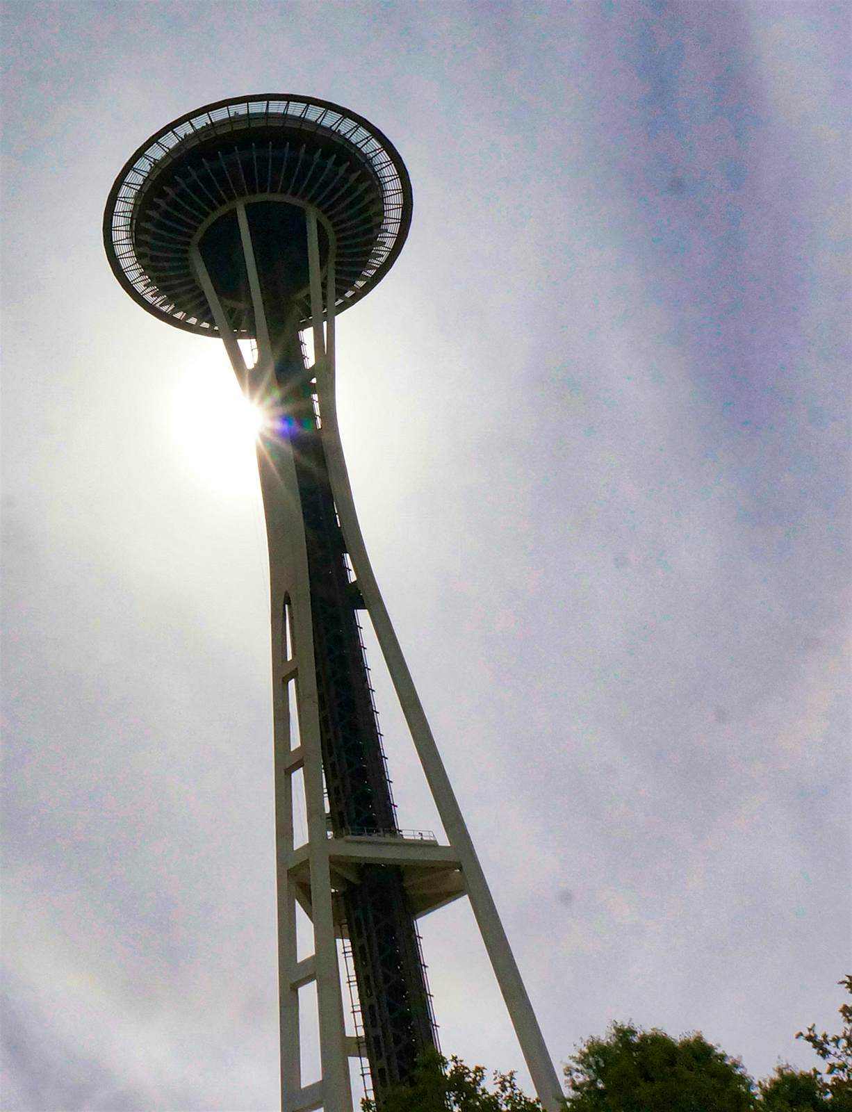 Features - 1600Needle-d927bcafacda A setting sun casts the Space Needle into profile as it drops behind the tripod tower and disc-shaped observation deck © Valerie Stimac / Lonely Planet