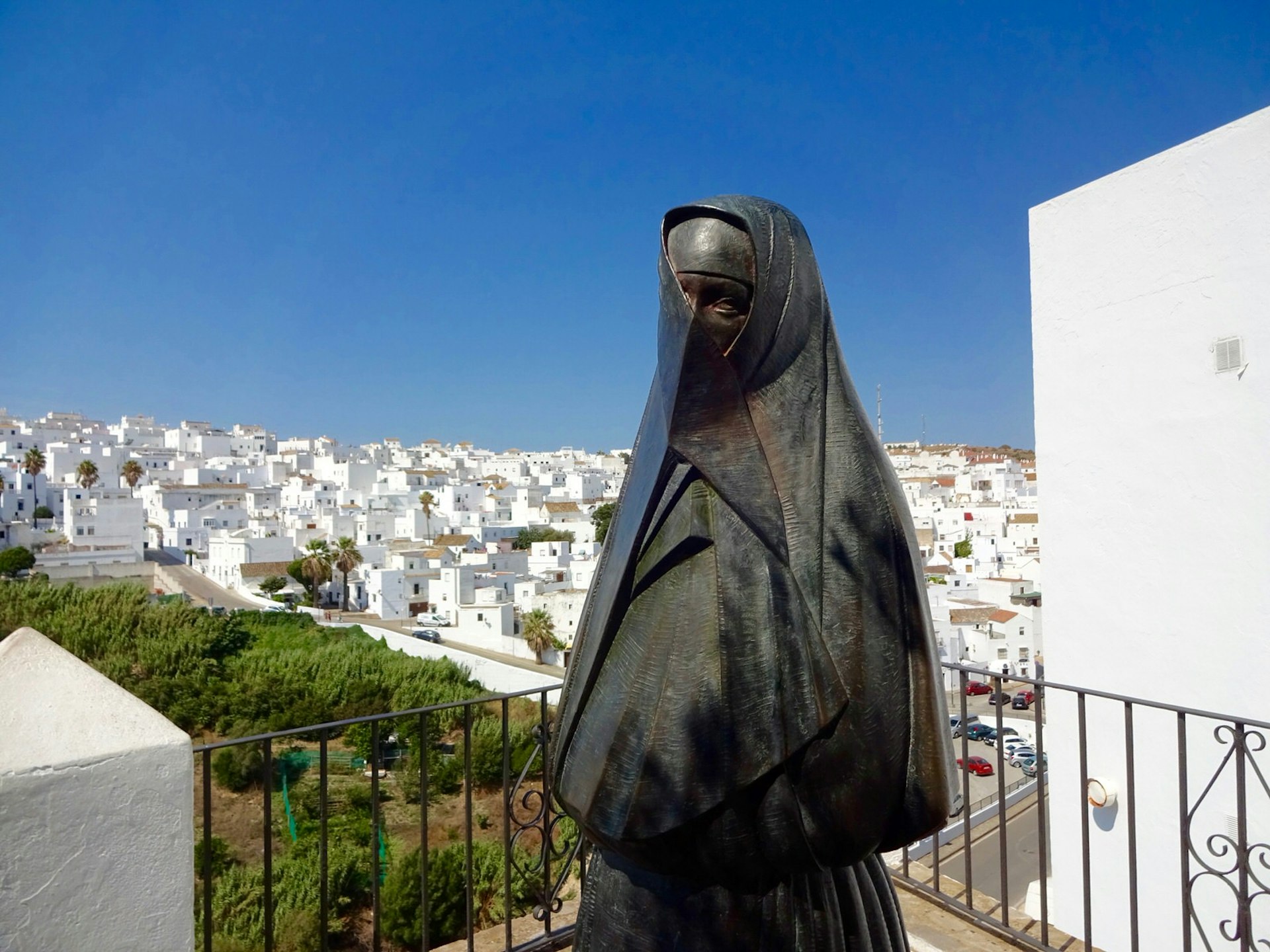 Statue of a cobijada - a Vejer woman dressed in the traditional local dress of a black cloak-like garment covering everything but the right eye - in Vejer's old town