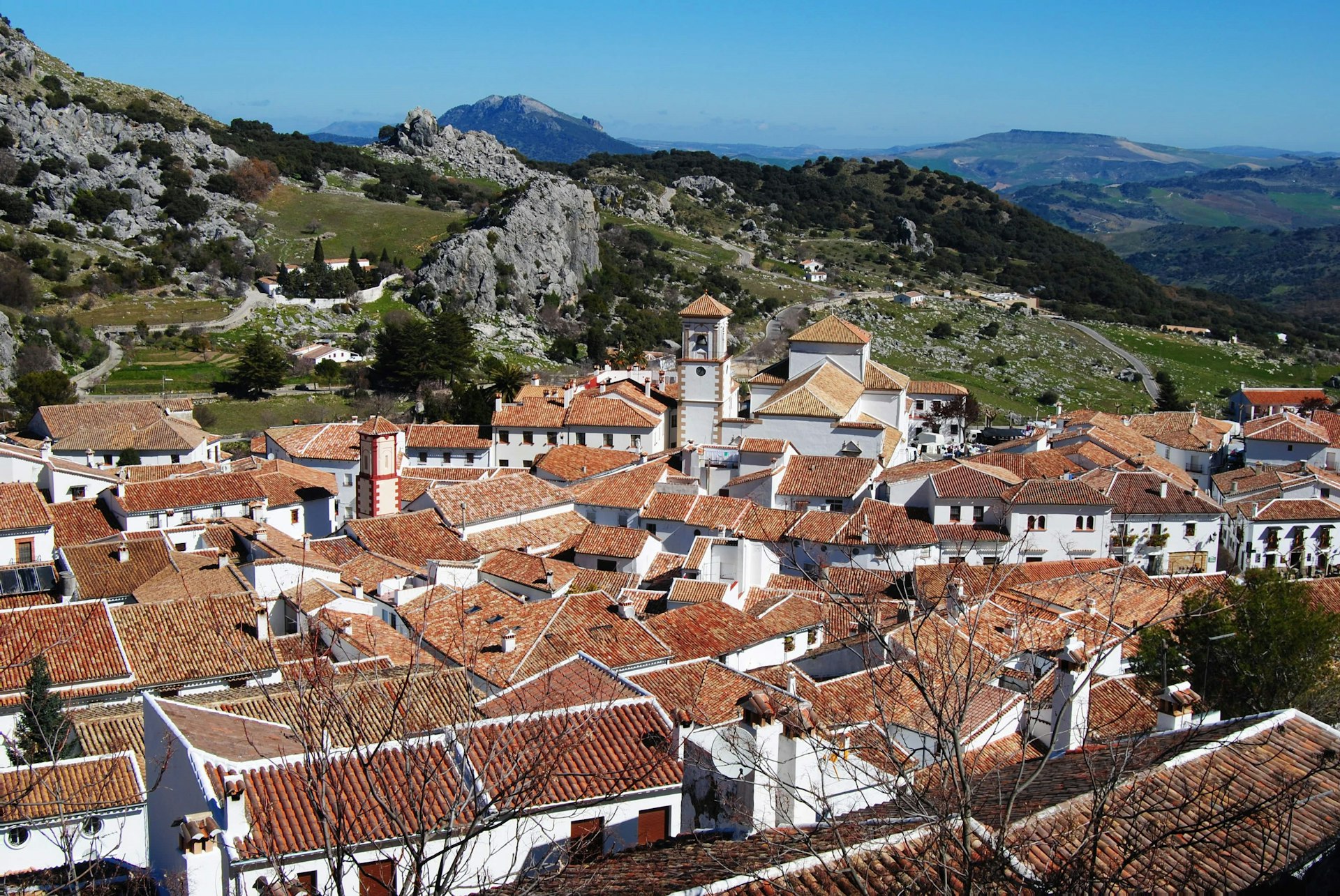 Grazalema village: white houses and red-tile roofs amid olive-green hills