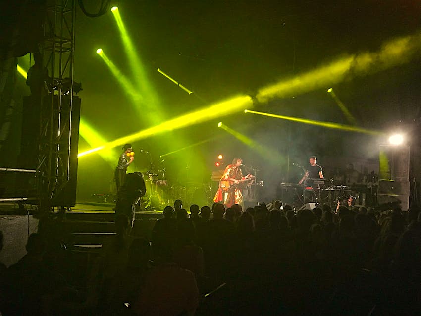 Features - IMG_1334-58a1529fa9c0 Yellow laser lights illuminate a smoky atmosphere on stage at a music festival