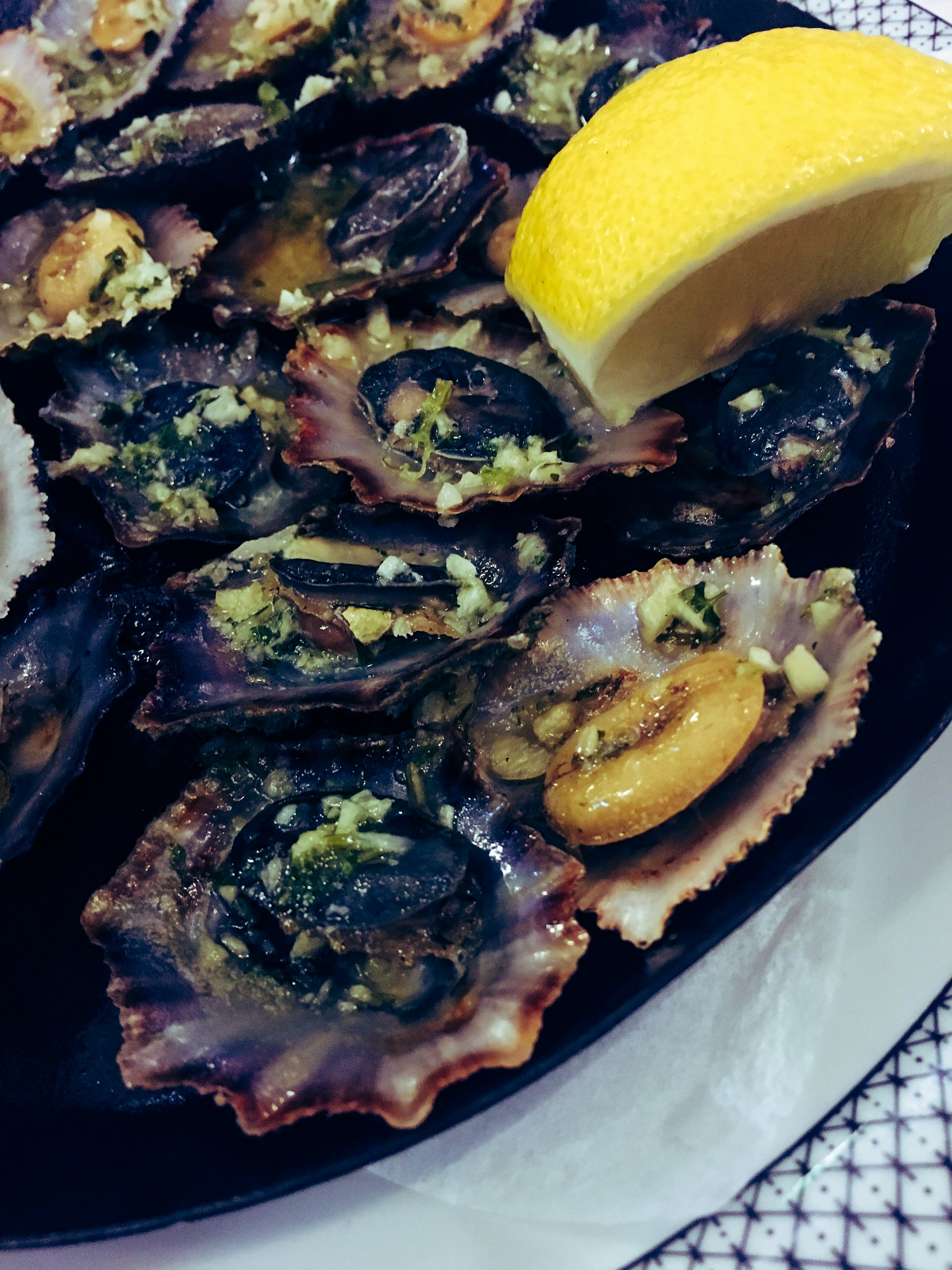 A plate of limpets served with garlic and lemon