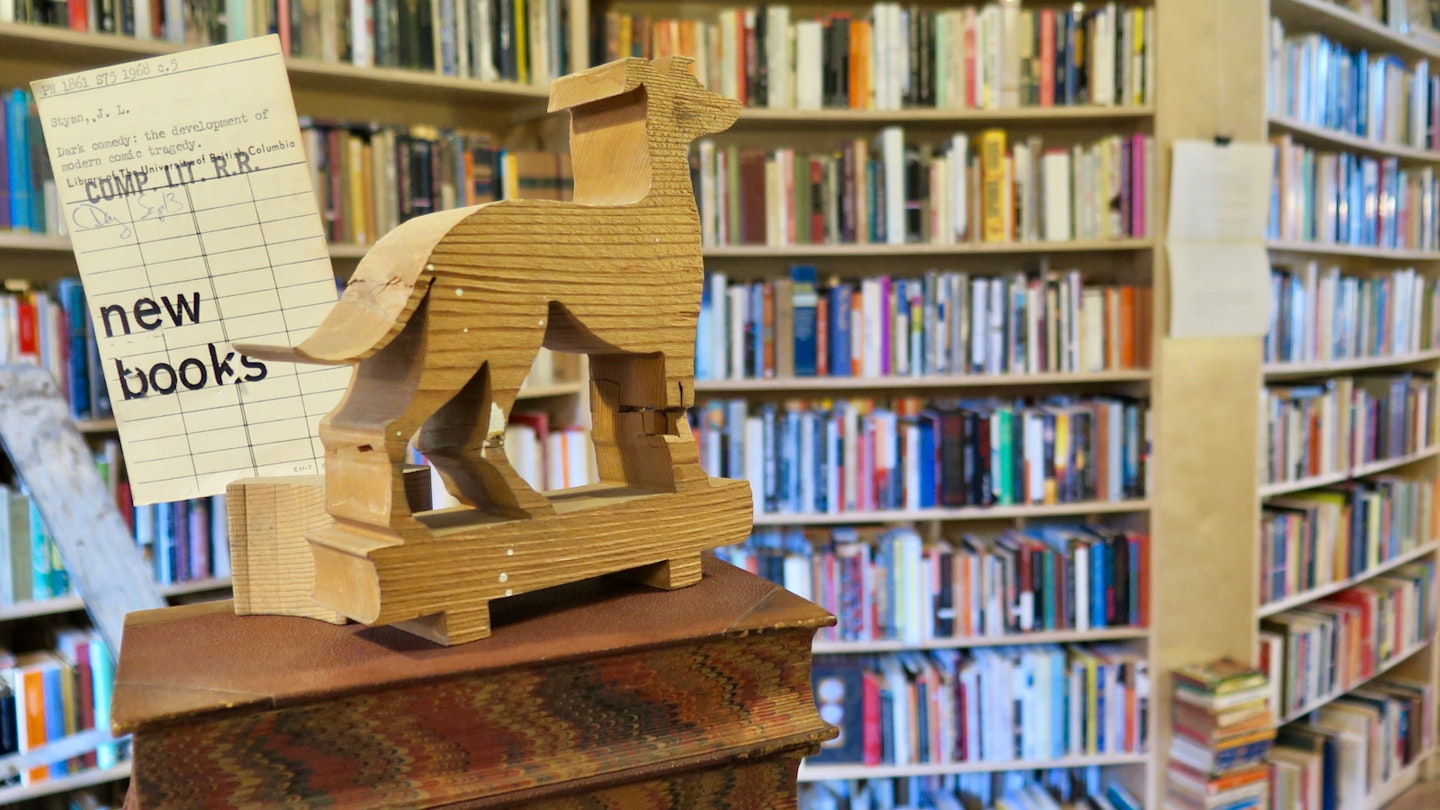 Books and a dog-shaped wooden carving inside the Paper Hound, Vancouver