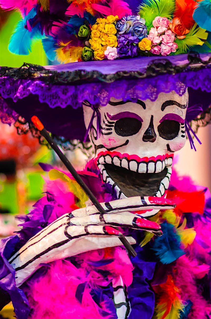 Features - San-Antonio-4b077ad7c4f1 a portrait of a very colorful catrina statue