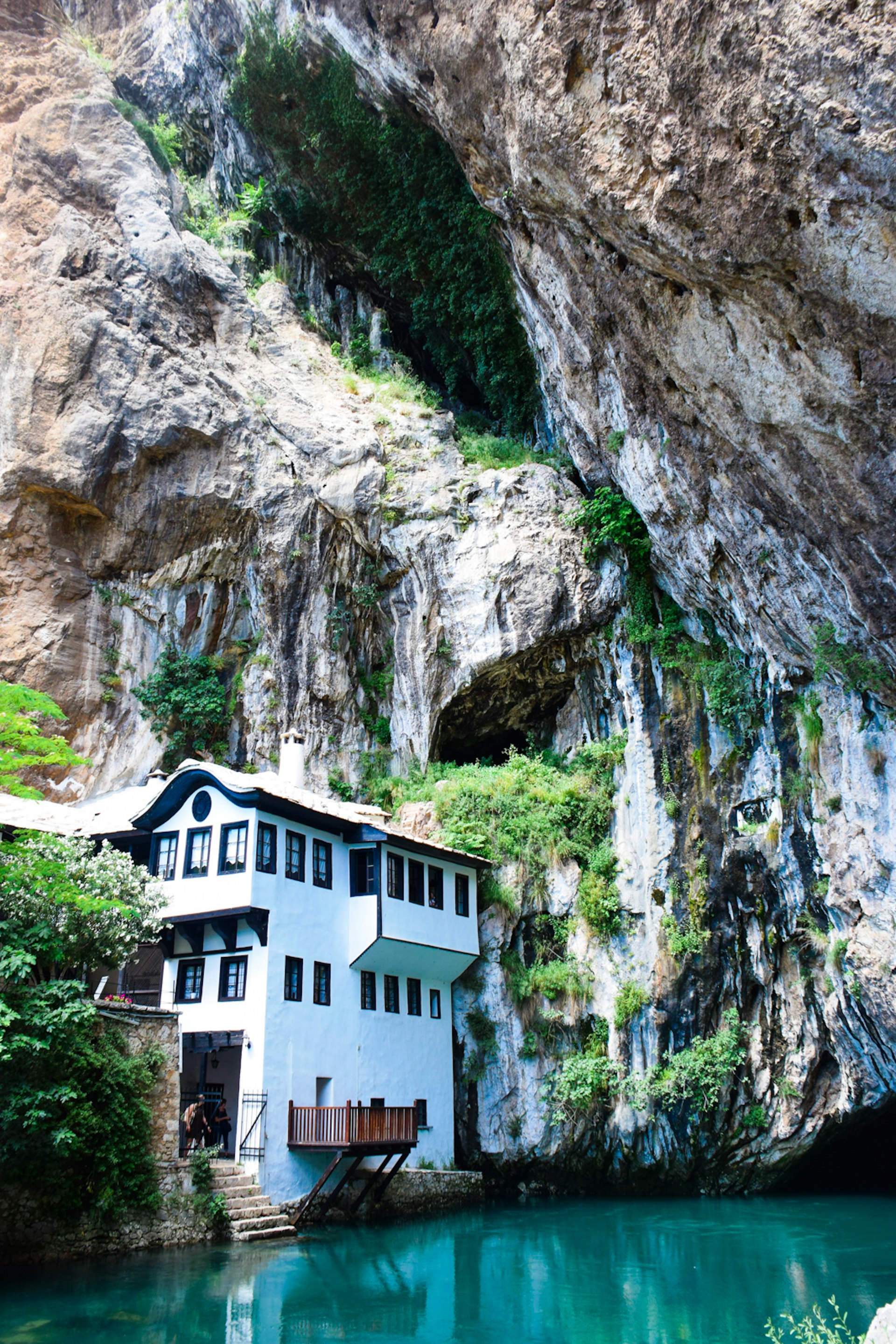 The Blagaj Tekija sits by the River Buna, overshadowed by precipitous cliffs