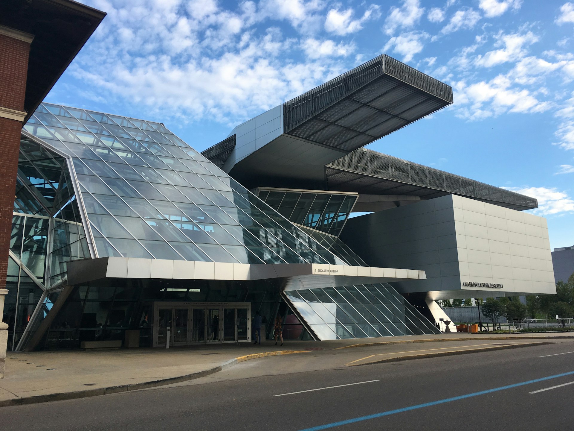 Exterior shot of the Akron Art Museum, a modern glass and concrete building 