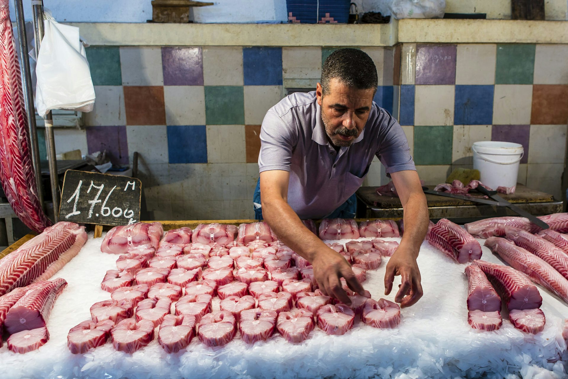 Vendor lays out fish at his stall at Tunis' Central Market