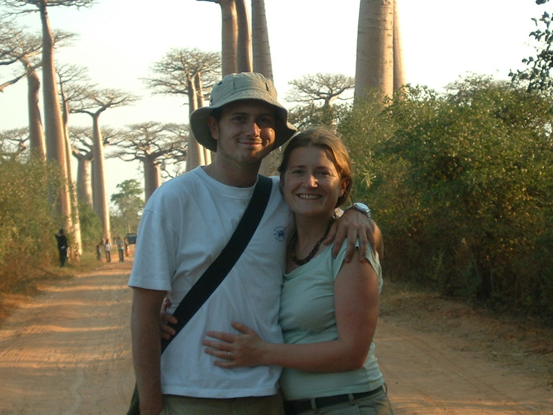 Imogen and Tom Hall pose in front of the baobab trees in Madagascar.