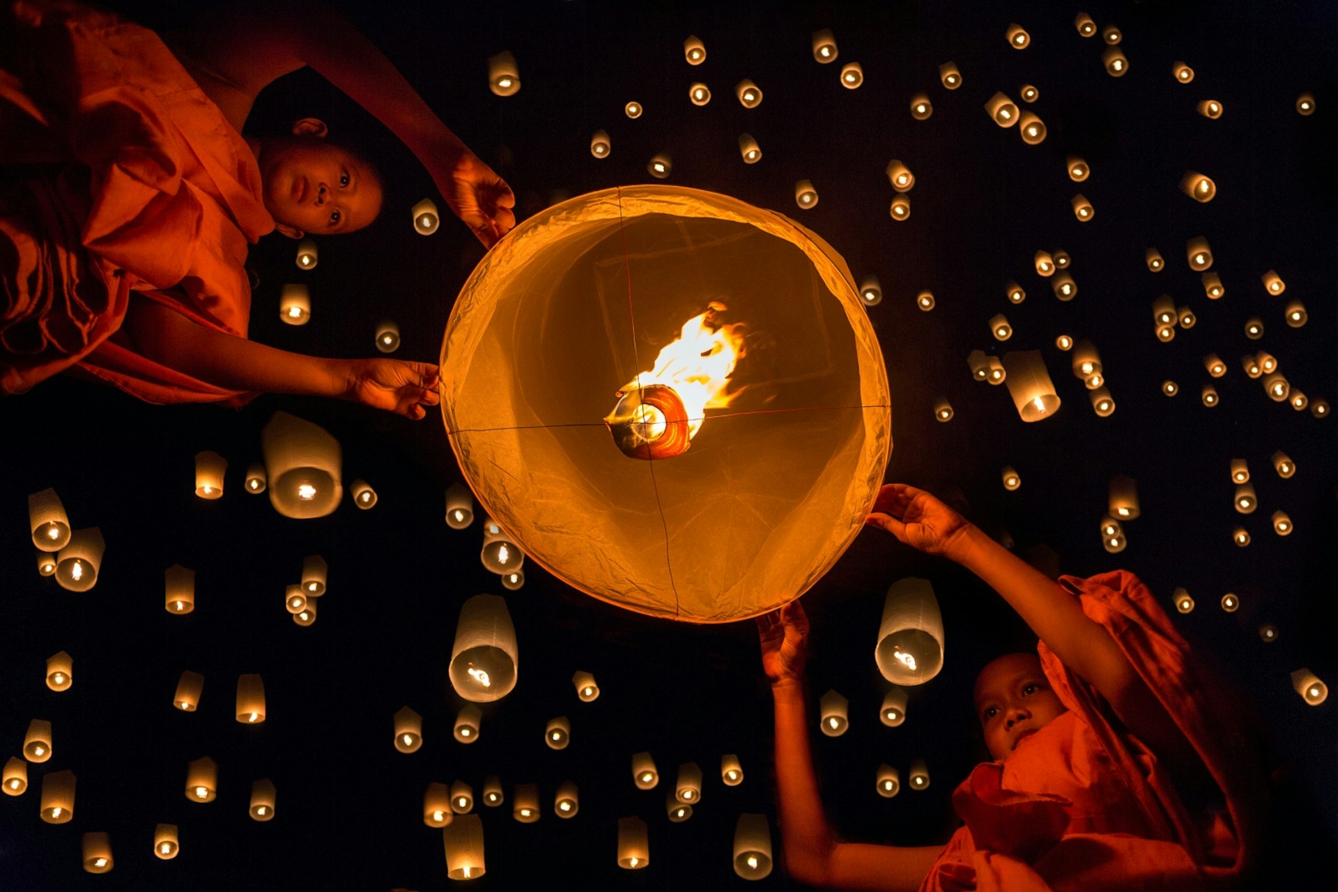 Novice monks release a lantern during Loi Krathong in Chiang Mai
