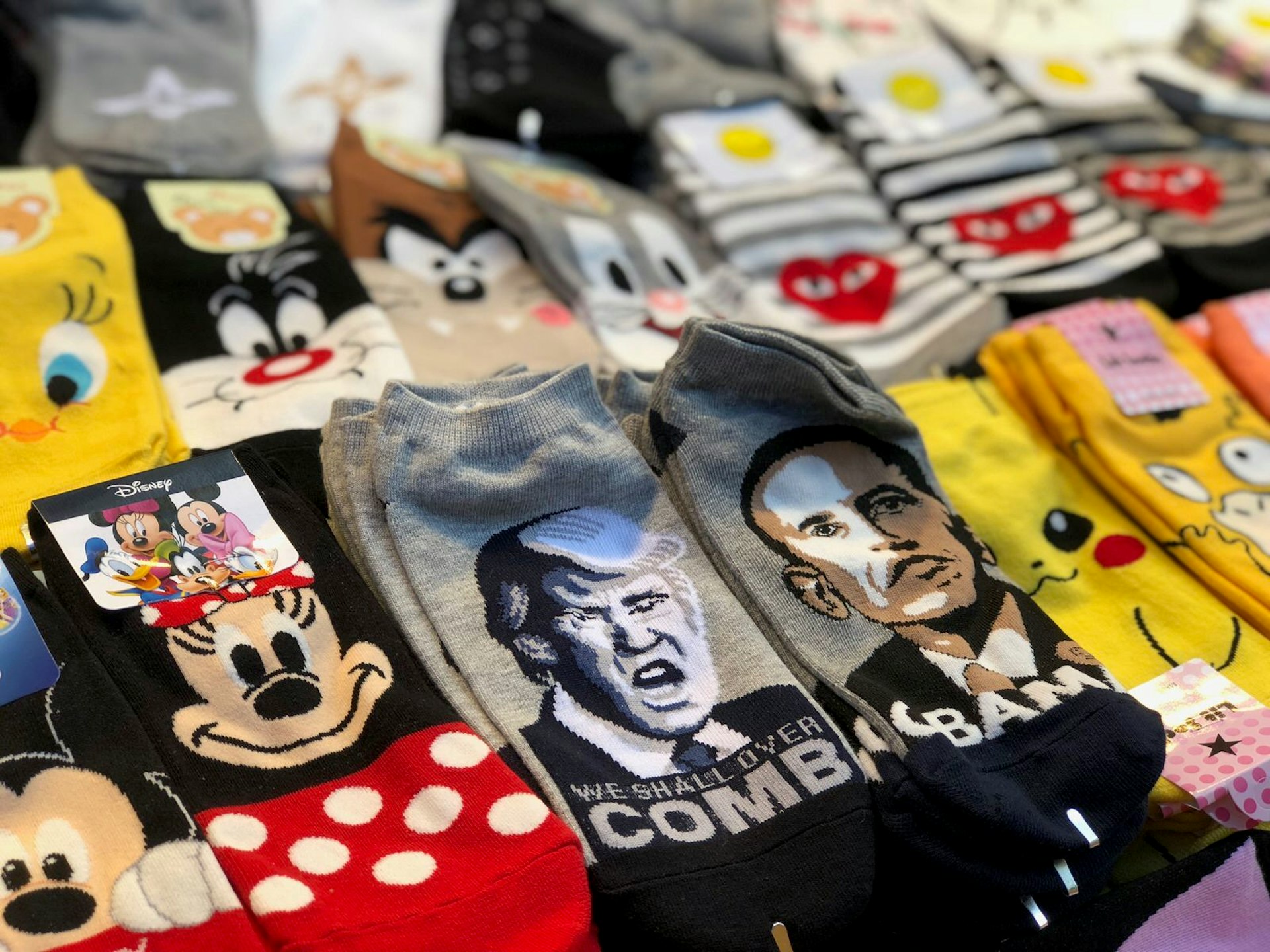 Pairs of socks depicting Minnie Mouse, Donald Trump, Barack Obama and several Loony Toons characters