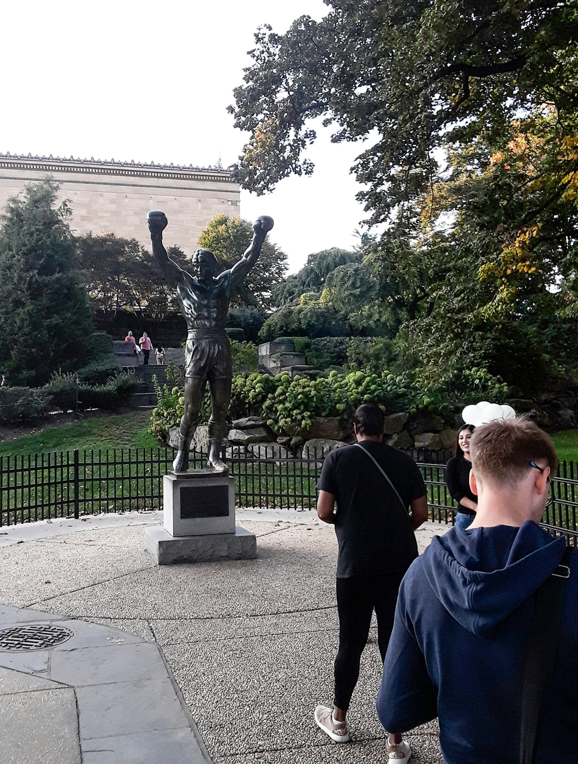 Two men line up to photograph the bronze Rocky statue in Philadelphia