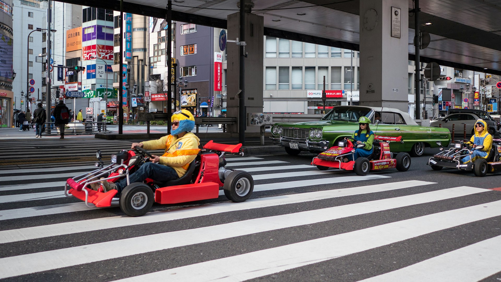 Costumed go-kart drivers pass on the streets of Tokyo