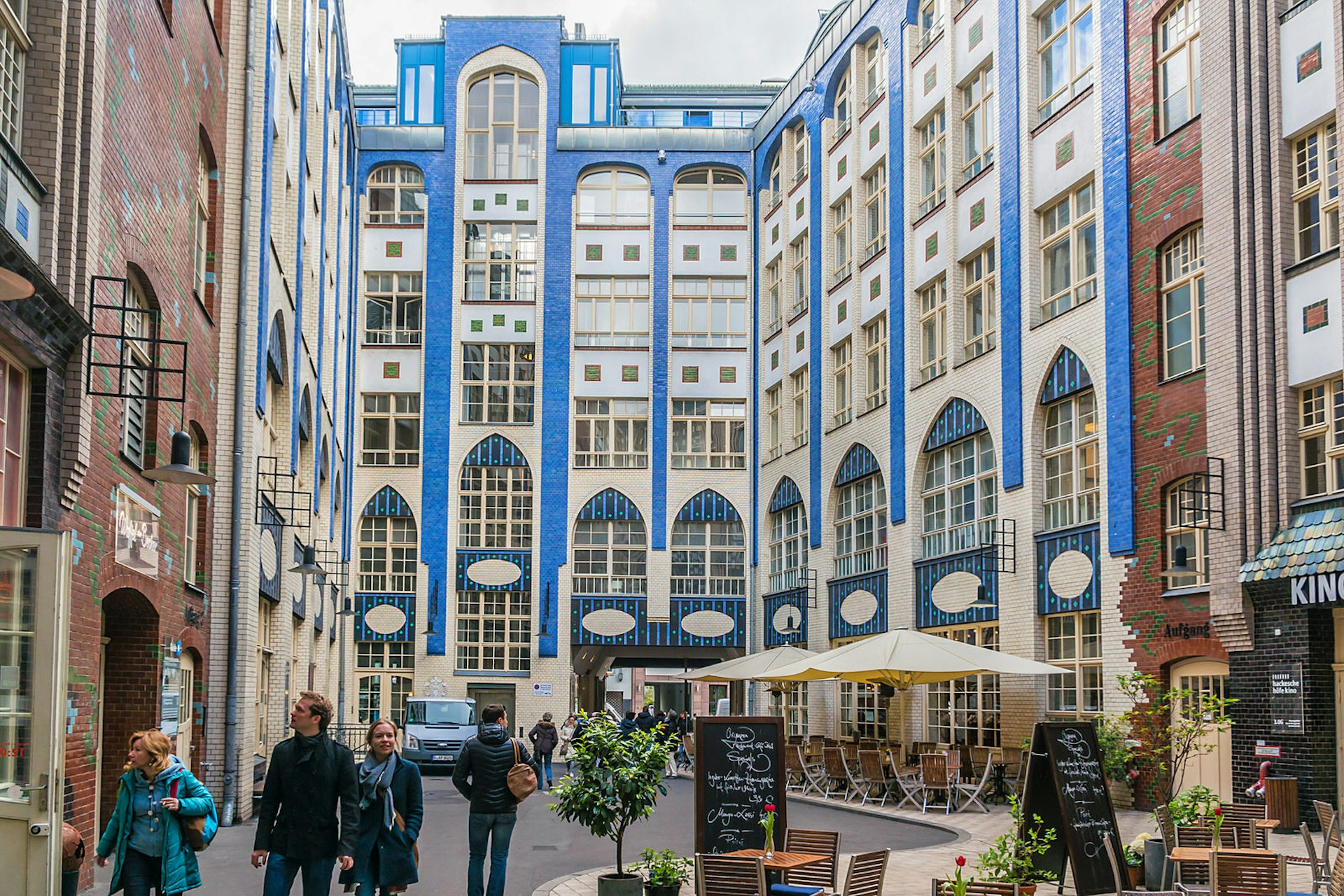 Hackesche Höfe is a series of courtyards joined together to one large complex with multiple uses. The buildings are covered with white and blue tiles.