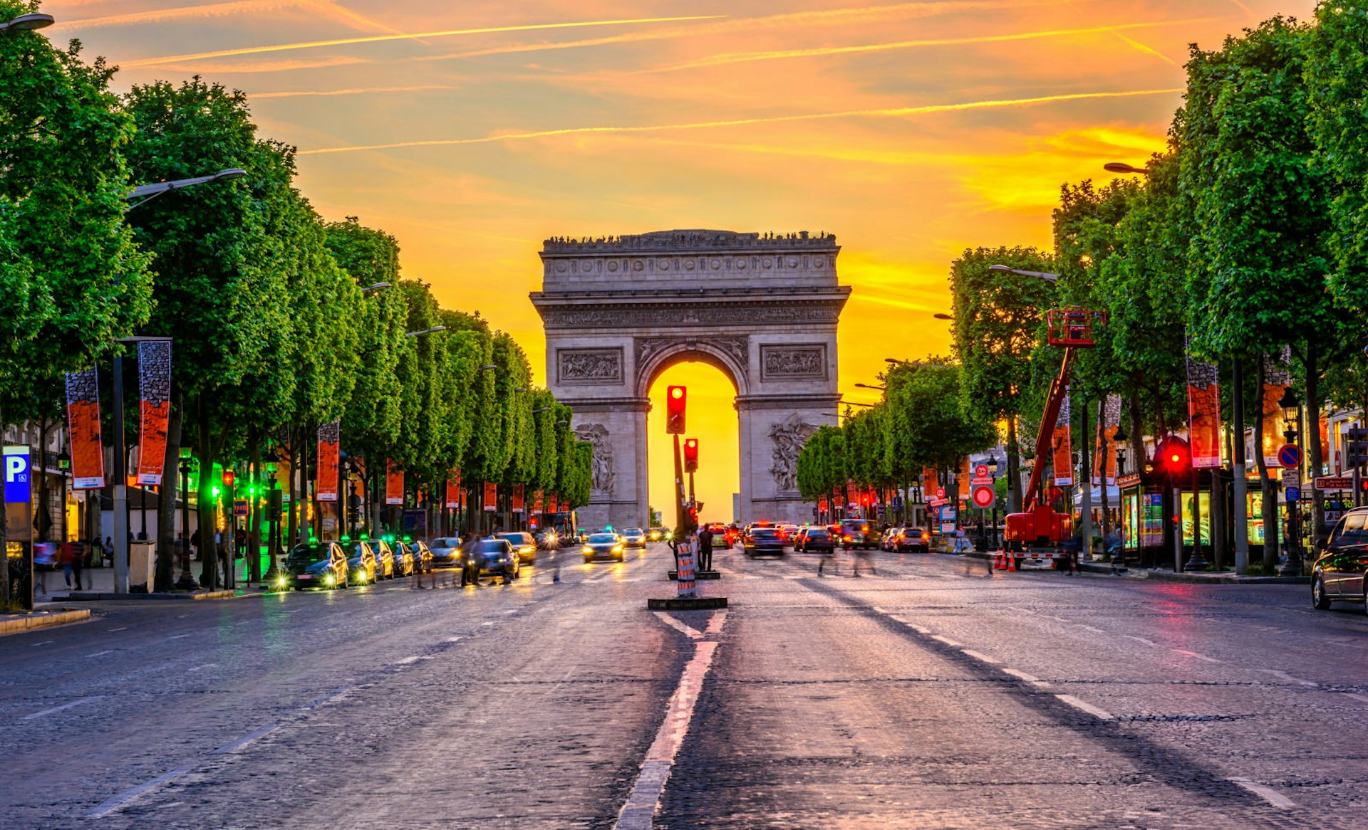 The golden sun sets over the av des Champs-Élysées in Paris, France