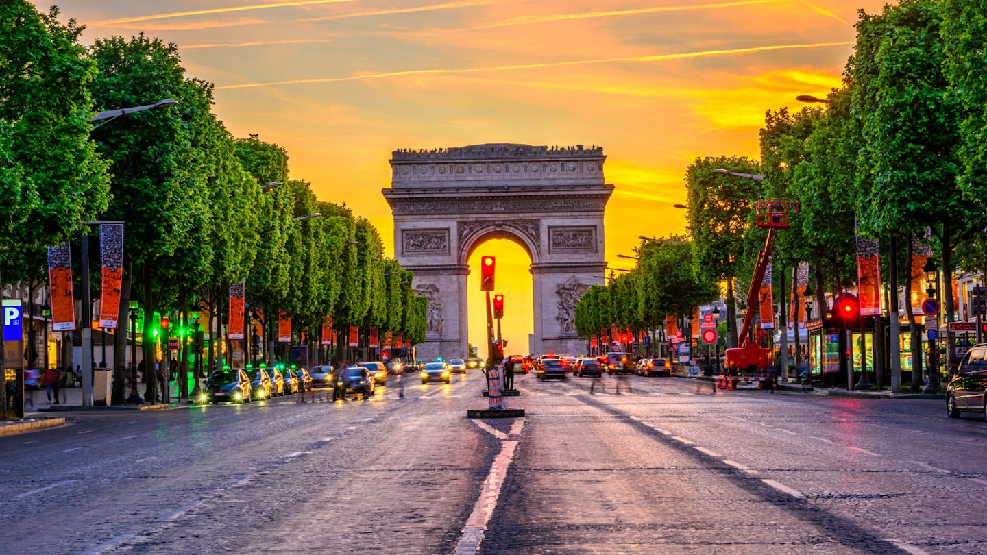 The golden sun sets over the av des Champs-Élysées in Paris, France