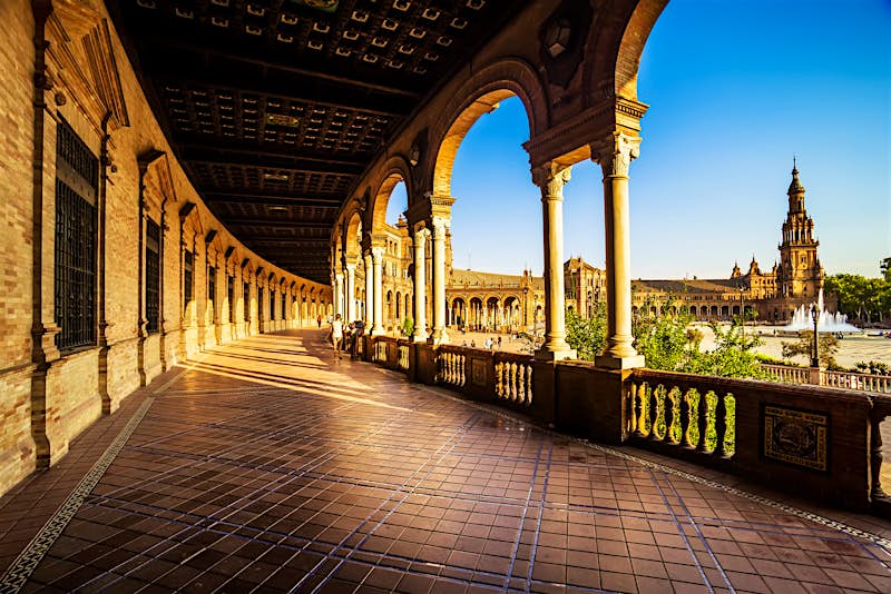 Features - shutterstock_156952541_1-4f5f77810590 A view of the covered walkway around Plaza de Espana, Seville, Spain