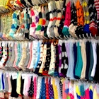 Several racks of socks in a variety of colours and patterns