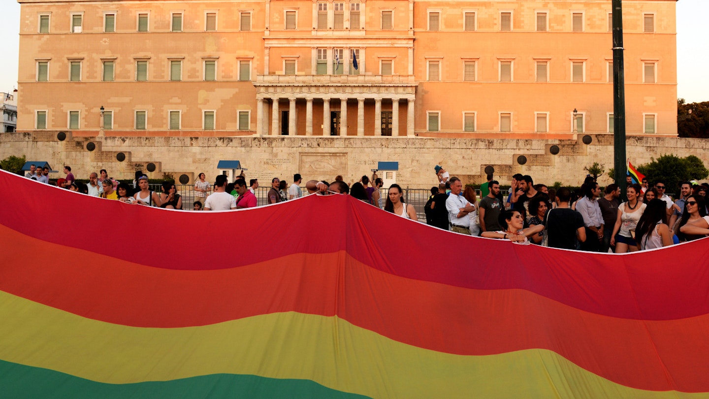 A huge rainbow flag in front of the Greek Parliament during the annual Pride parade © Kostas Koutsaftikis / Shutterstock
