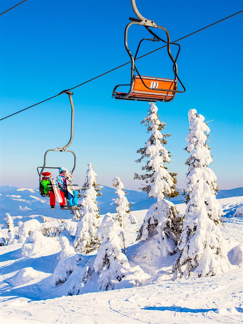 The chairlift at the Carpathians' Drahobrat ski resort on a sunny winter day © Sun_Shine / Shutterstock