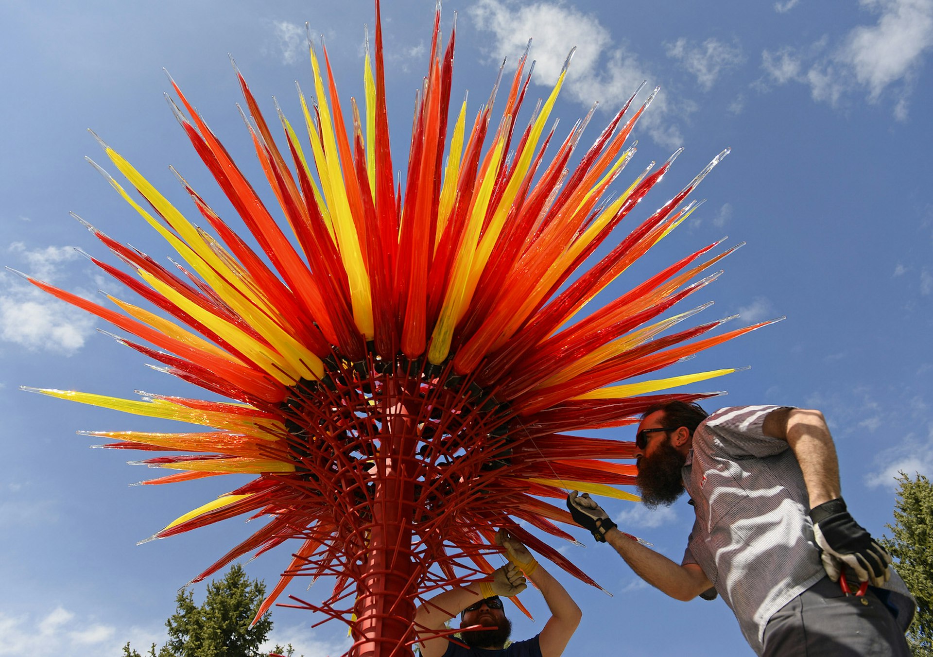 Workmen installing a sculpture at Denver Botanic Gardens, Colorado