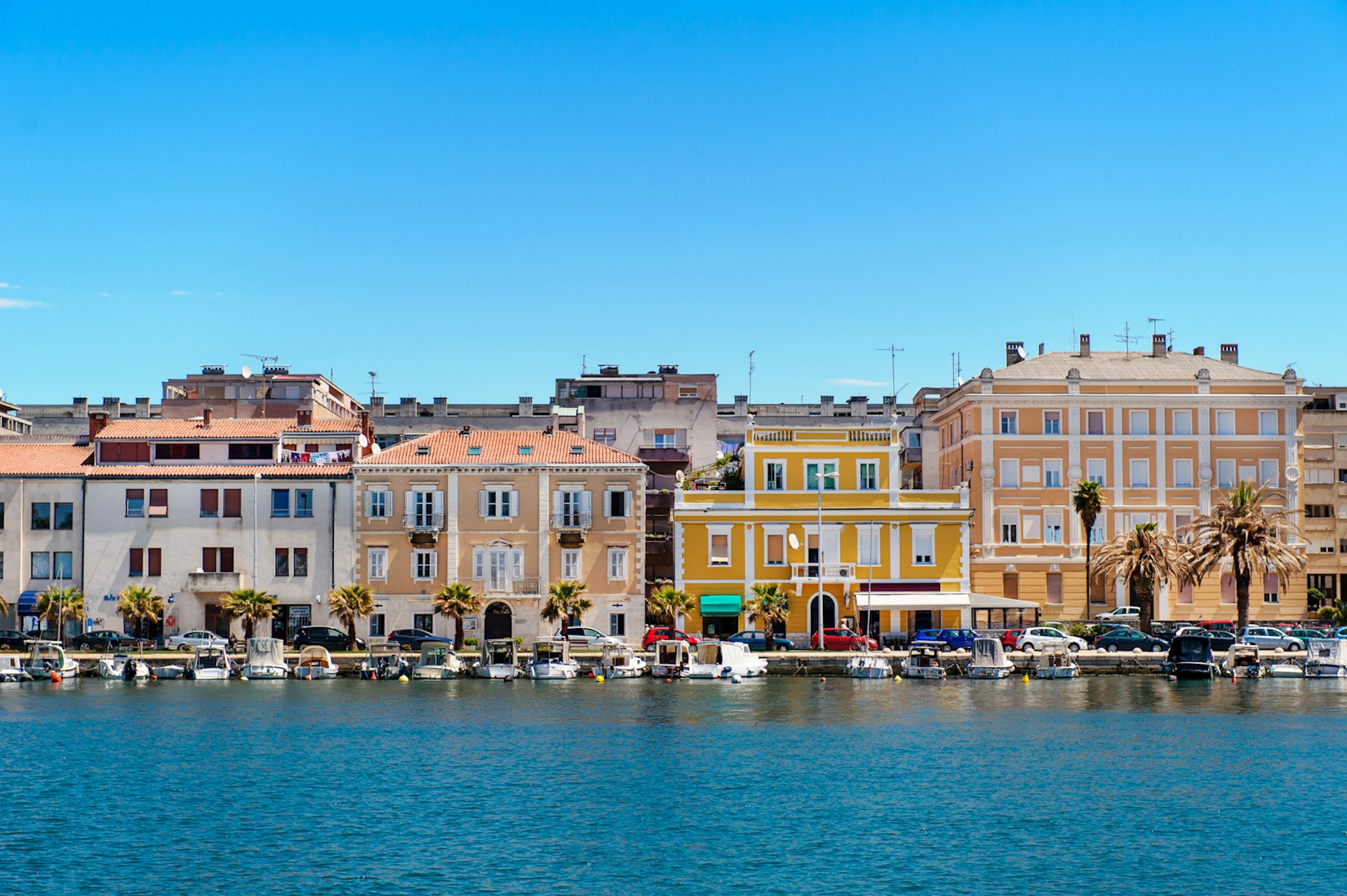 Zadar, orange houses, turquoise sea and blue sky, Croatia.