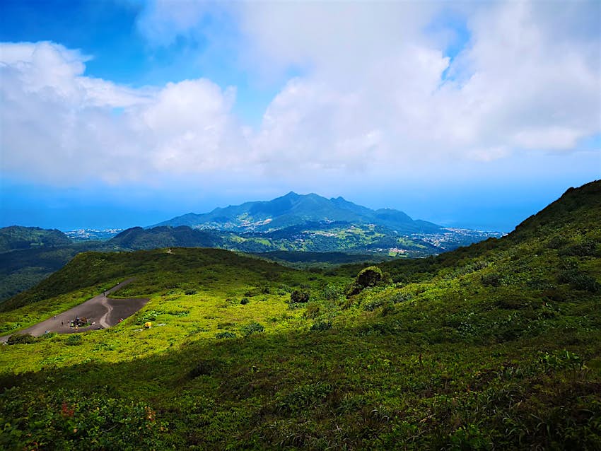White clouds hover above the volcano, La Soufrière, in Guadeloupe © Laura French/ Lonely Planet 