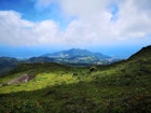 White clouds hover above the volcano, La Soufrière, in Guadeloupe Laura French/ Lonely Planet
