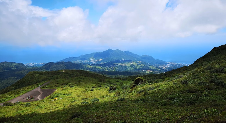 White clouds hover above the volcano, La Soufrière, in Guadeloupe Laura French/ Lonely Planet