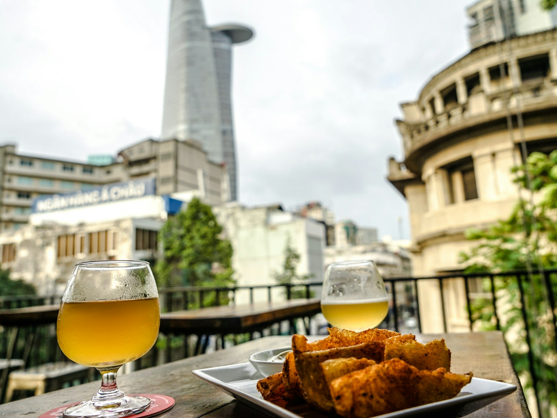 Craft beer and chips overlooking Ho Chi Minh City at Rogue