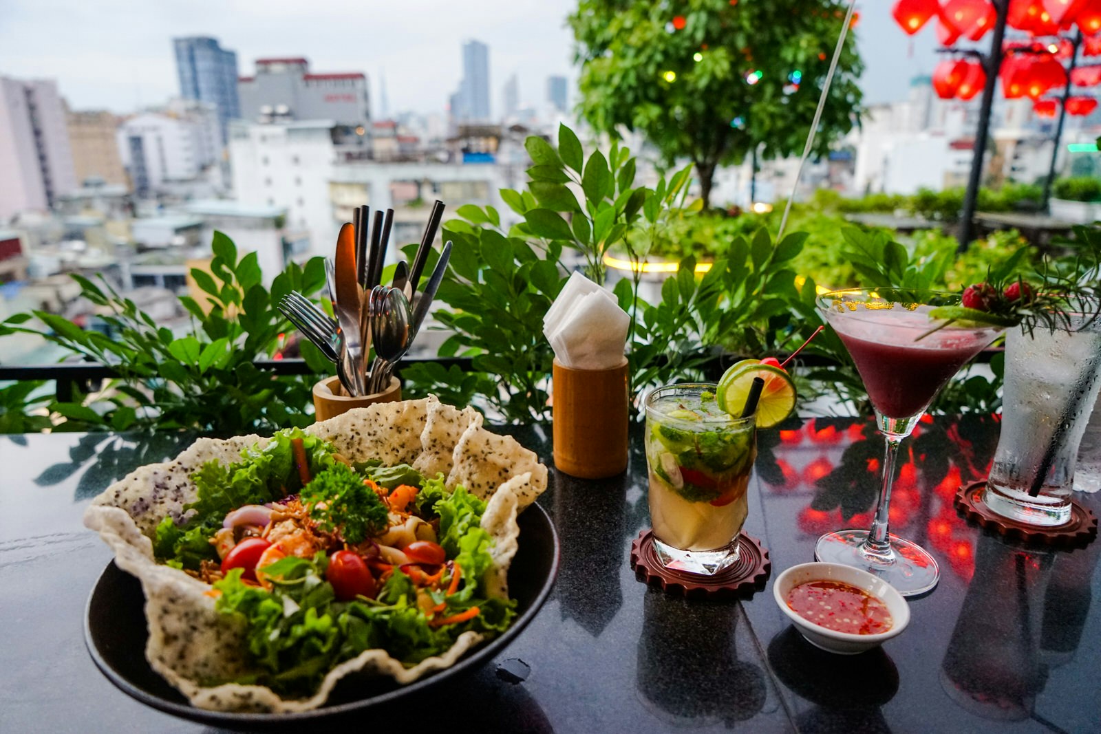 A salad and a cocktail at the View. The leafy, green salad is in an edible chip bowl. 
