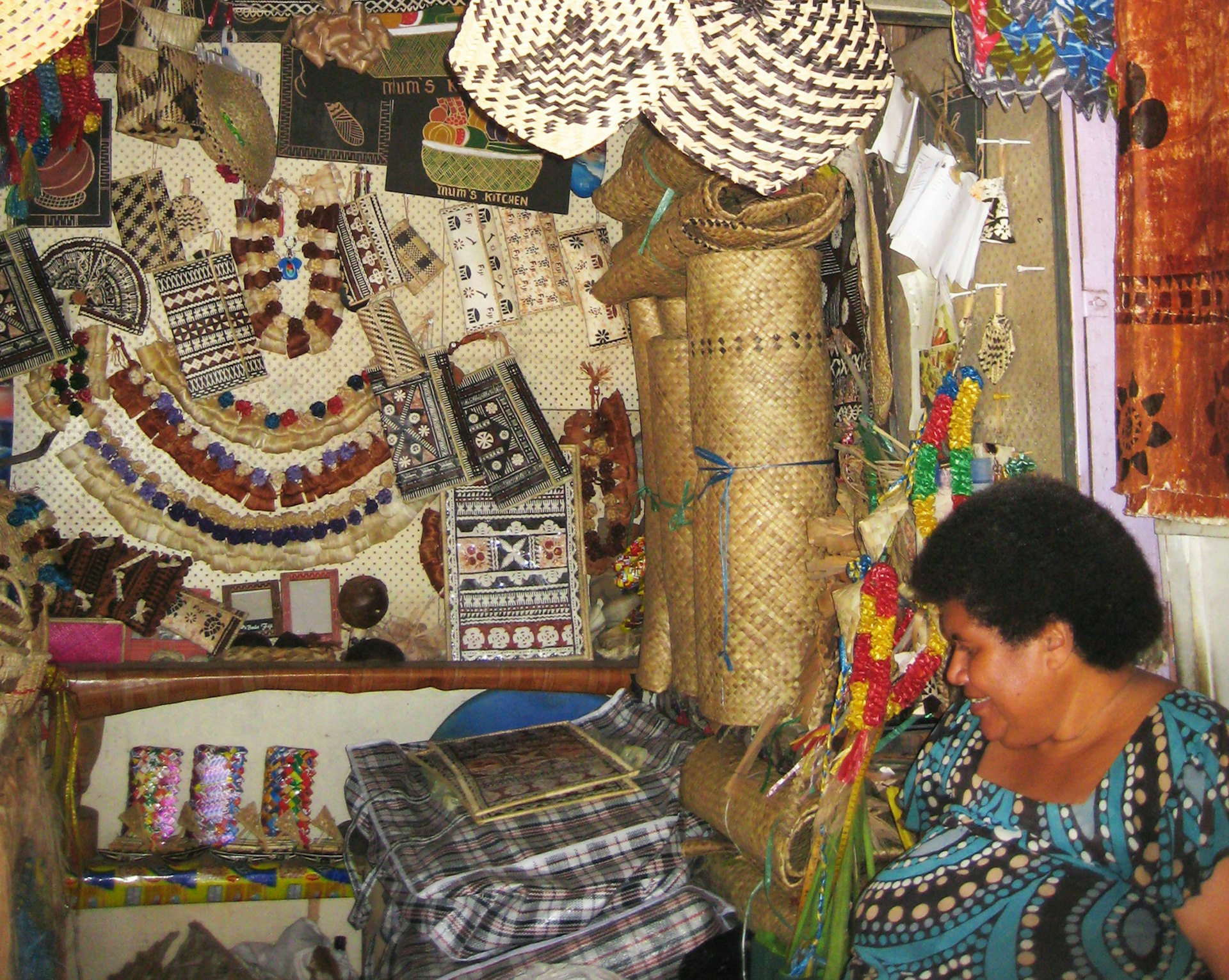 A shopkeeper in front of her wares in Fiji