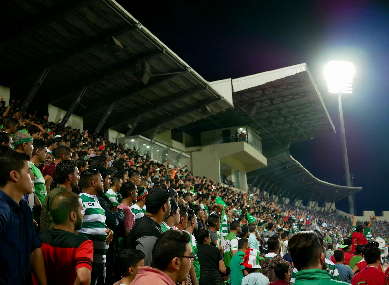 Wehdat fans closely watch a match against Al Faisaly near Amman, Jordan