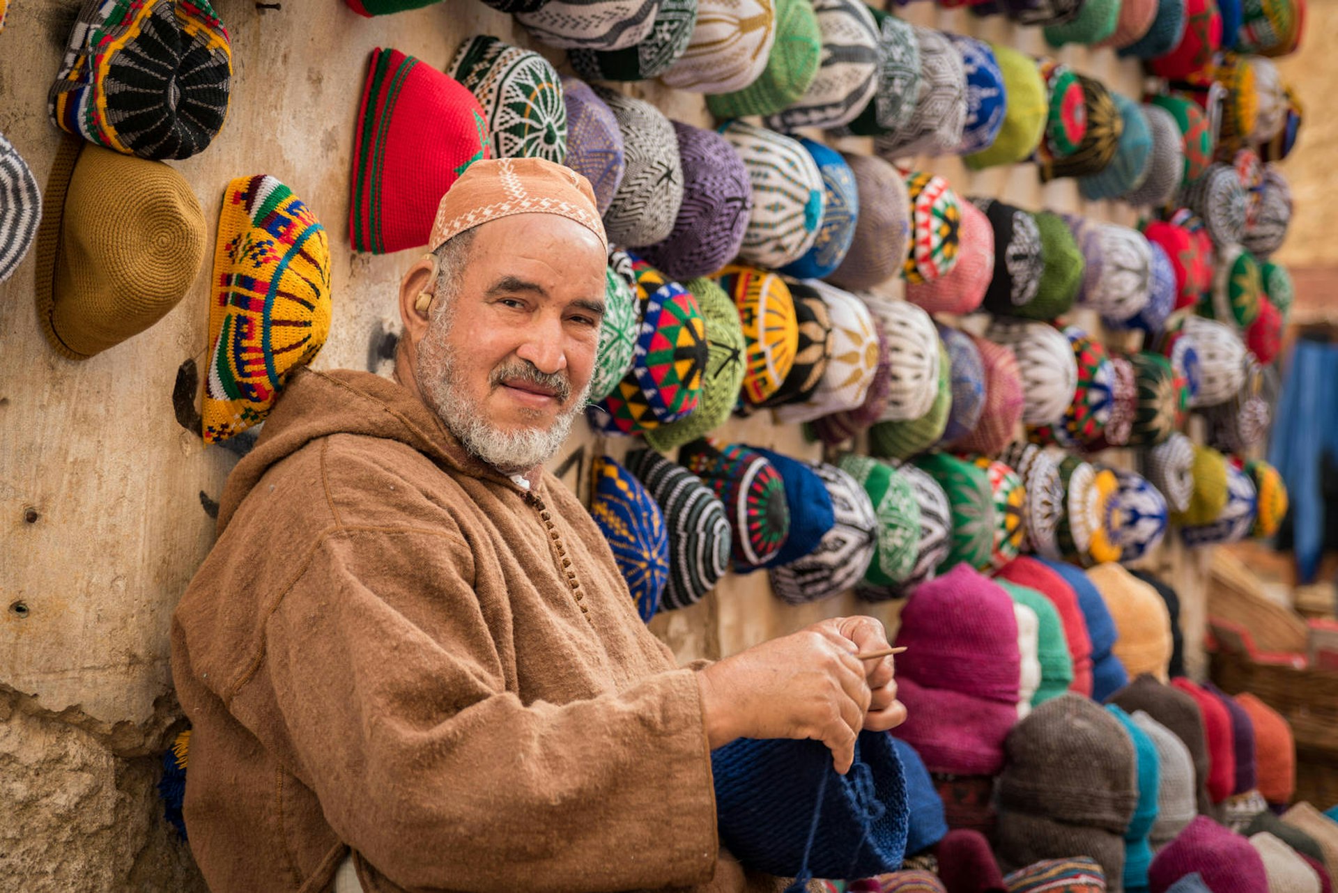 A hat seller works on his products in Marrakesh
