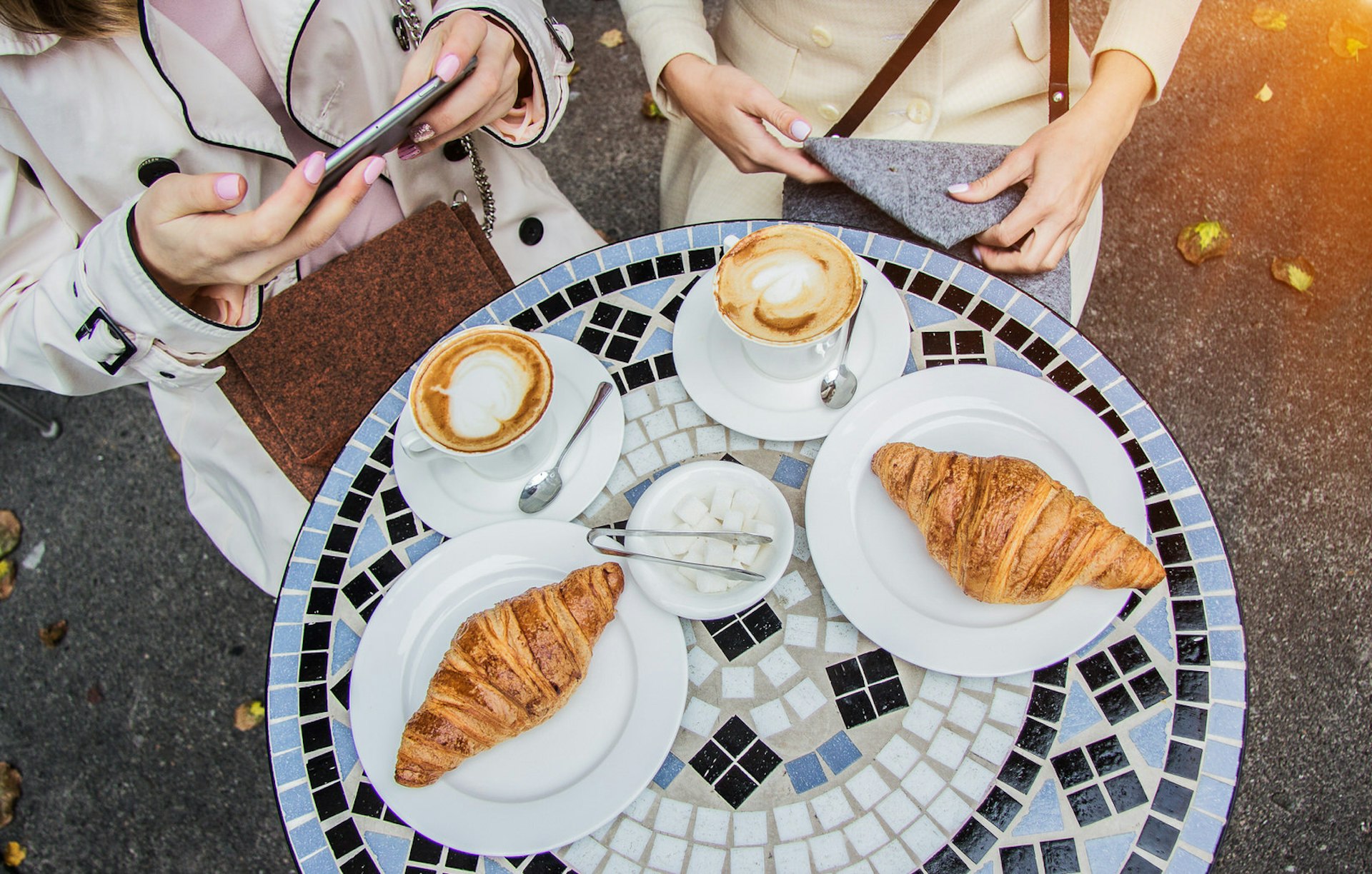 A tabletop laden with croissants and coffee in Paris
