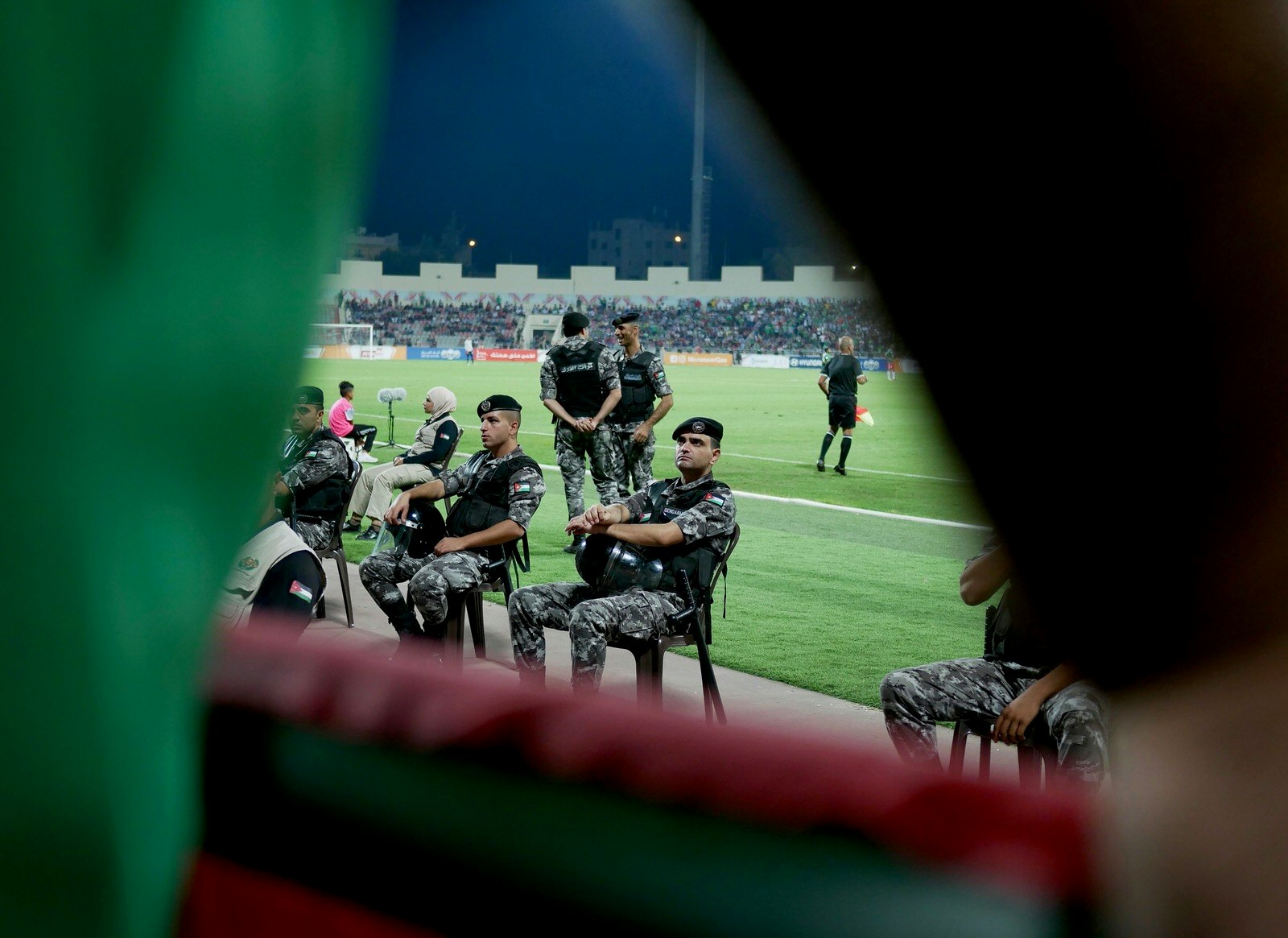 Riot police surround the field during a Wehdat v Faisaly football match in Amman, Jordan