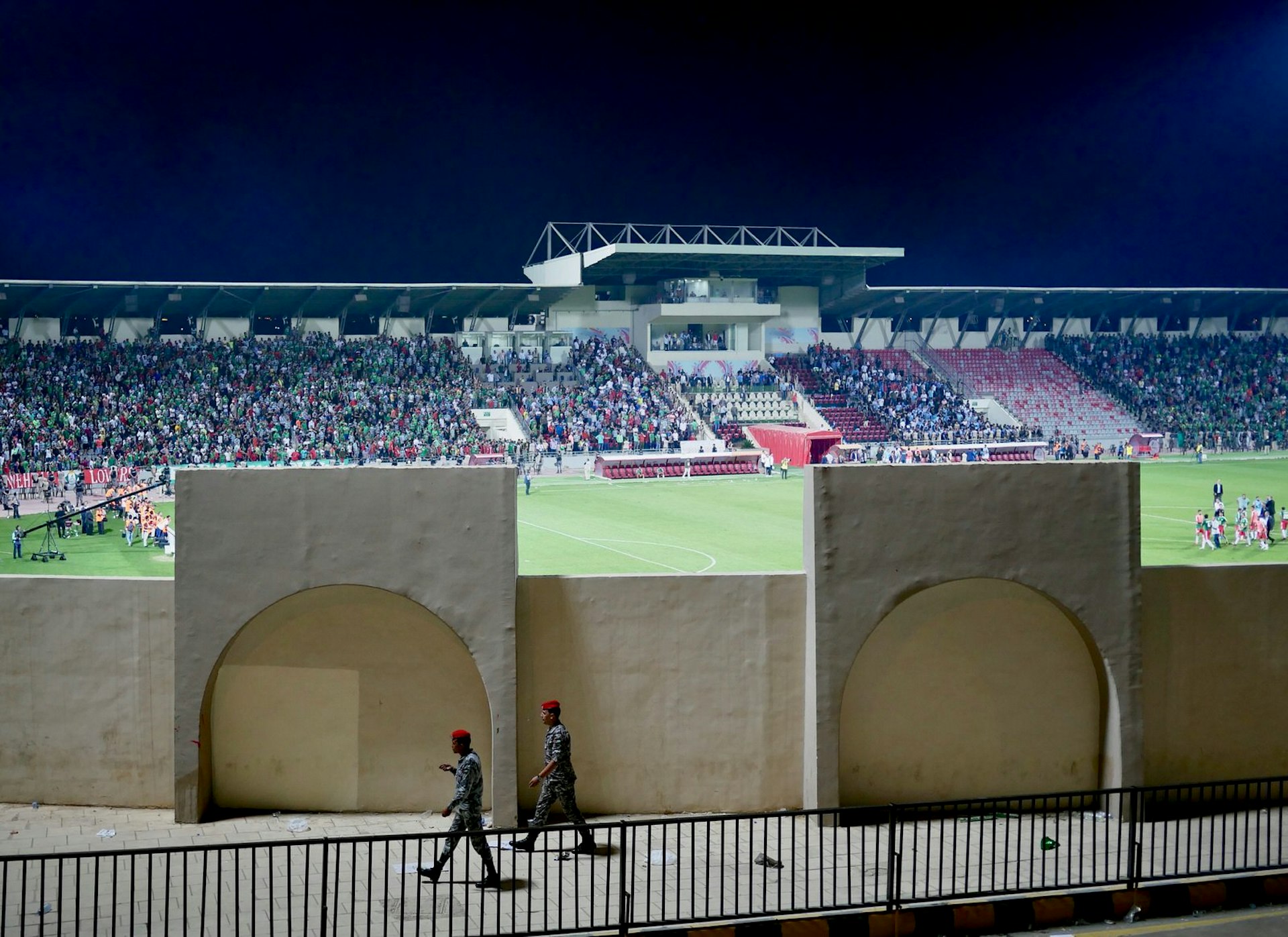 Security guards patrol the premises of the King Abdullah II stadium complex during the Faisaly vs Wehdat football match near Amman, Jordan