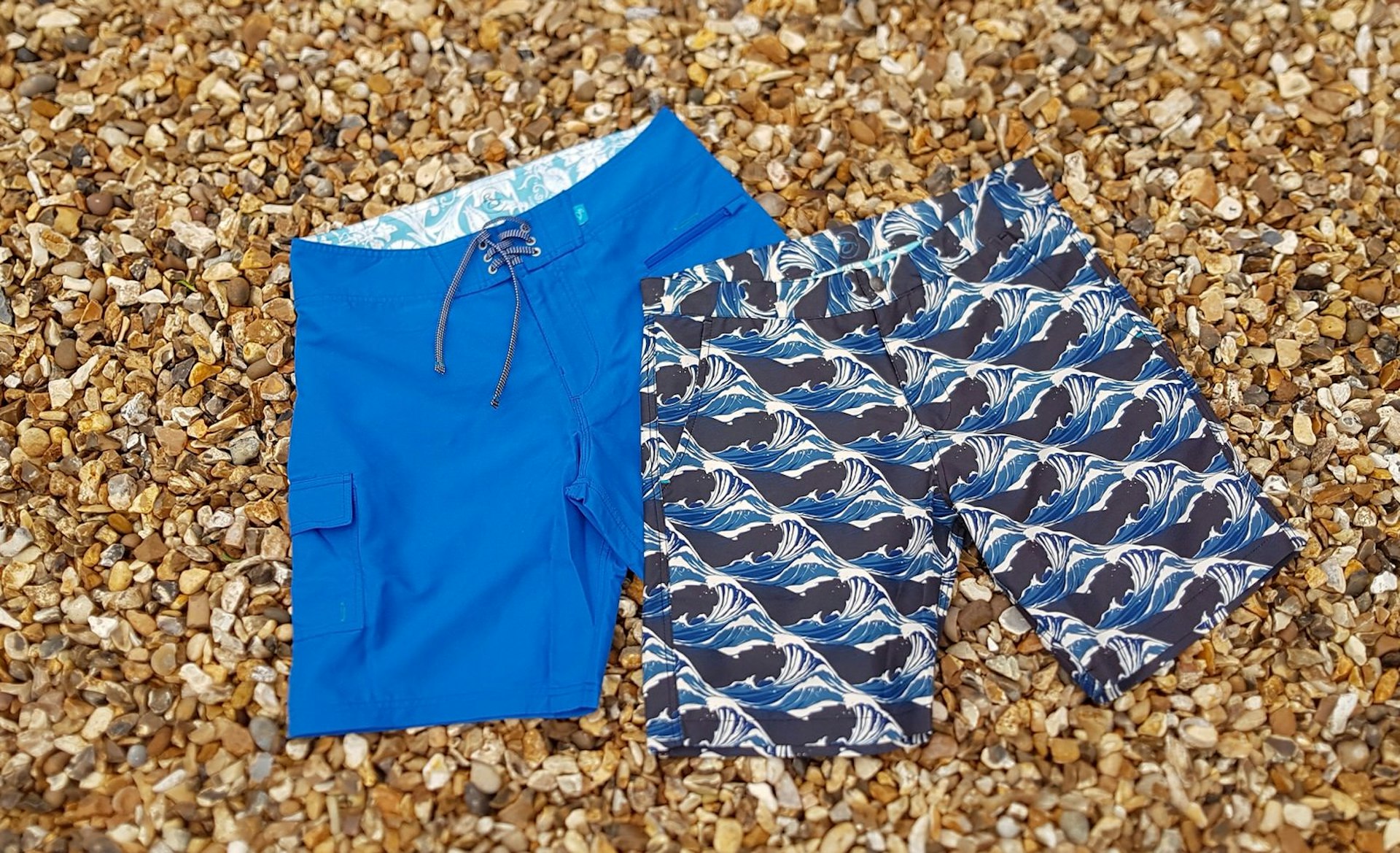 Two pairs of Riz Board Shorts, shown in plain blue and a wave pattern