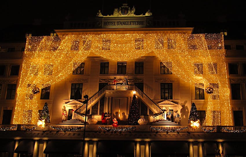 An elegant display of Christmas lights adorns the facade of the upmarket Hotel d'Angleterre © Caroline Hadamitzky / Lonely Planet