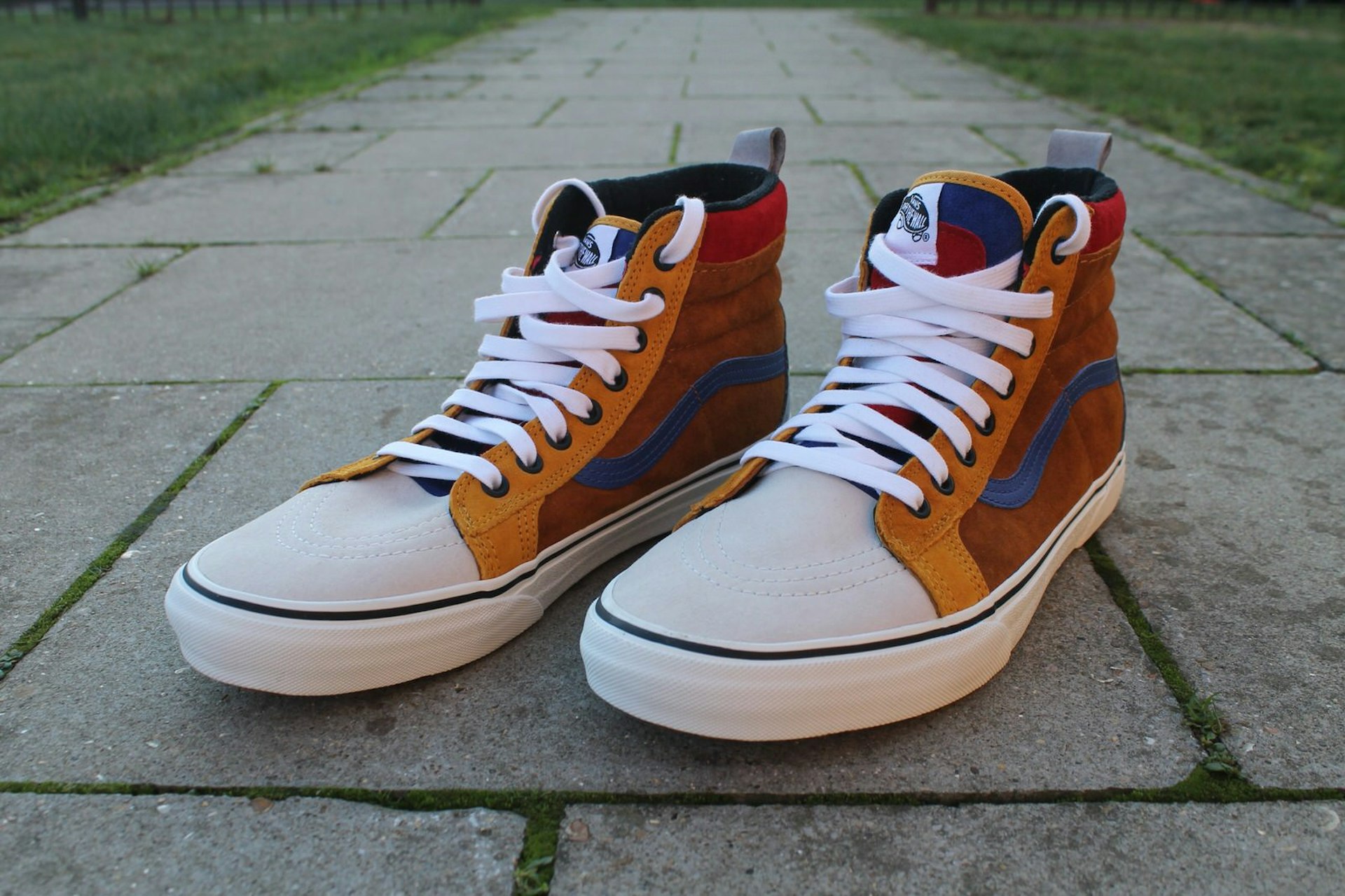 A pair of Vans SK8-HI MTE high-top trainers shown in an eye-catching colour design that includes splashes of brown, blue, yellow and red