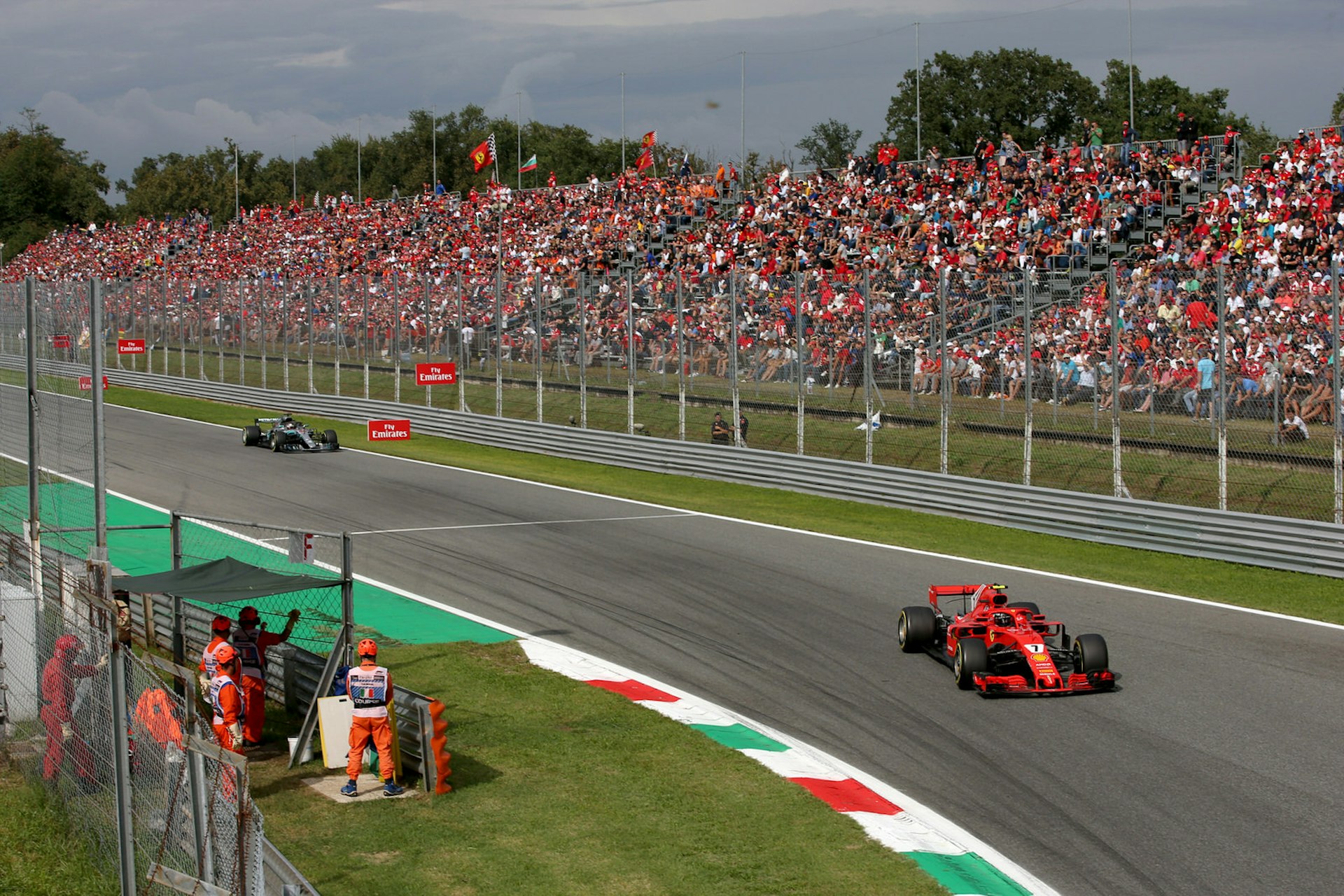 Formula One cars drive around the Monza race track