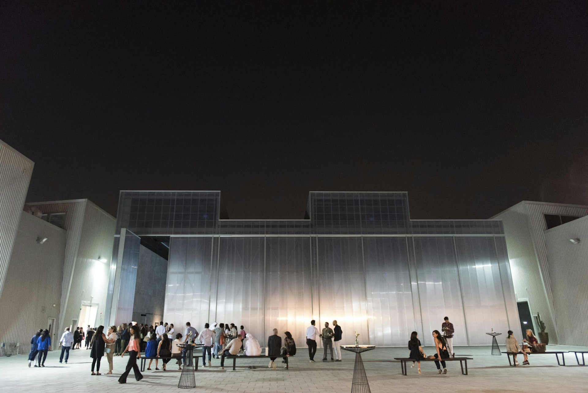Crowd mingles outside Concrete, a gallery in Alserkal Avenue, Dubai, United Arab Emirates
