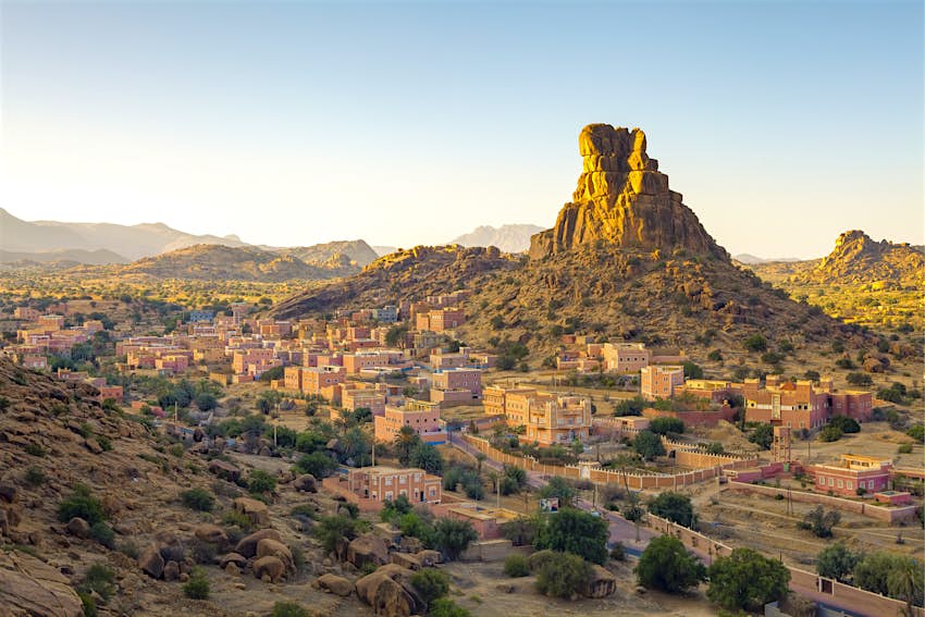 The Berber village of Aguerd-Oudad and the rock formation known locally as Le Chapeau de Napoleon (Napoleon's Hat) illuminated at sunrise
