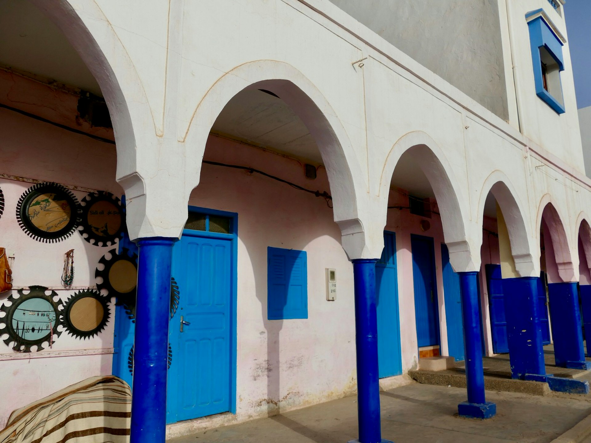 Blue and white arches along one of two main streets in Mirleft, Morocco