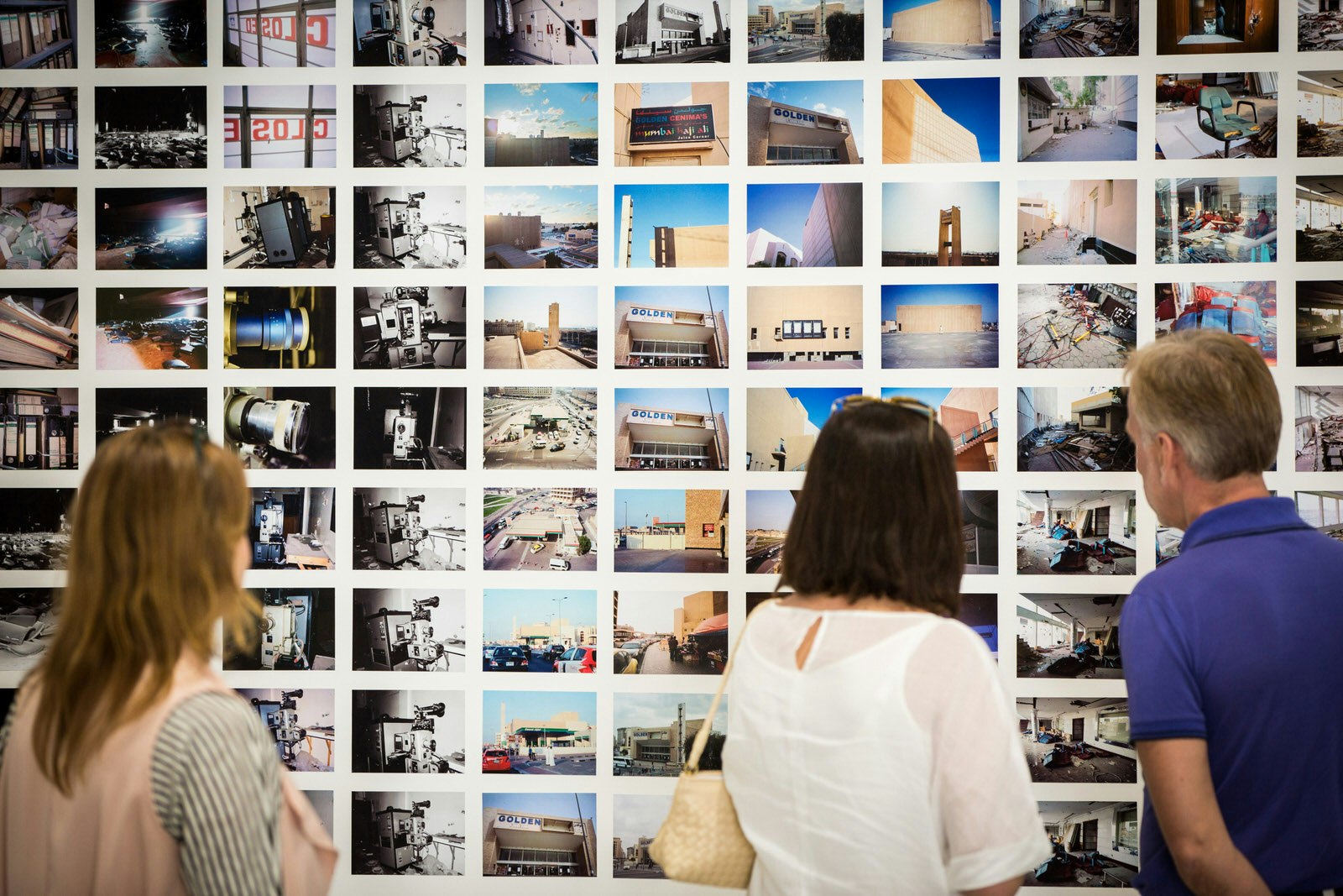 Visitors look at photographs during Art Week at Alserkal Avenue at Alserkal Avenue, Dubai