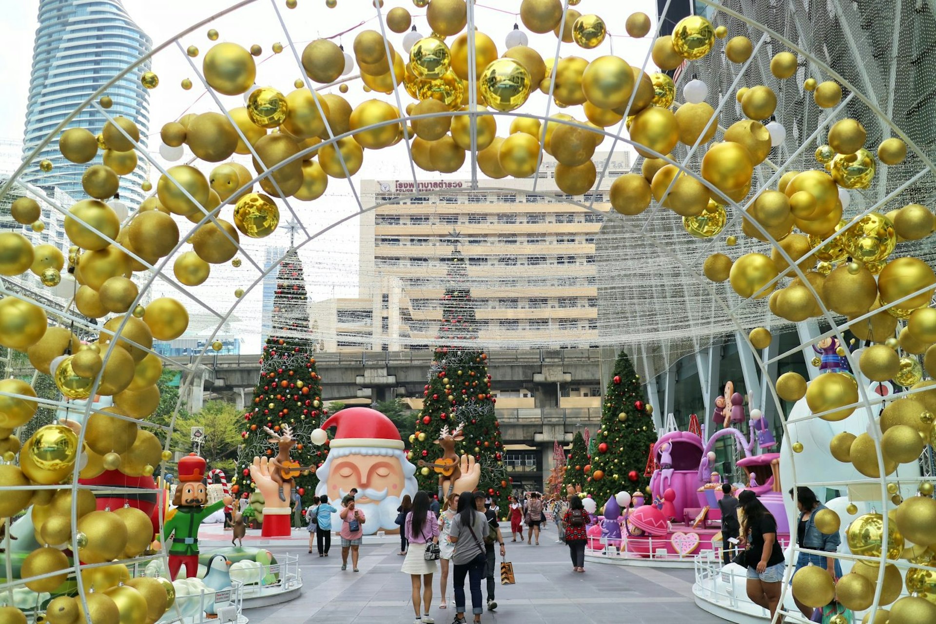 Groups of people walk around CentralWorld shopping centre which is decorated for Christmas every year.