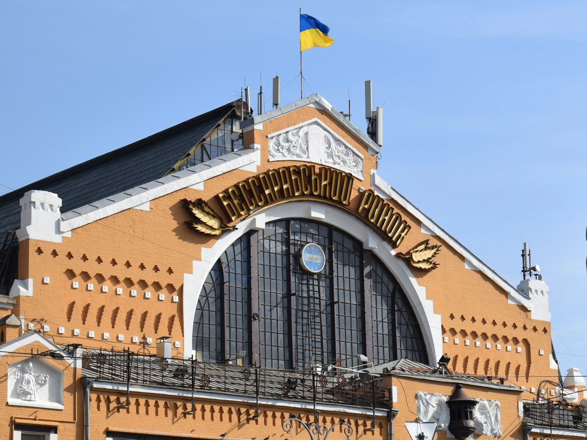 The peach and white art-nouveau facade of the Bessarabsky Rynok market in Kyiv on a sunny day with clear blue skies