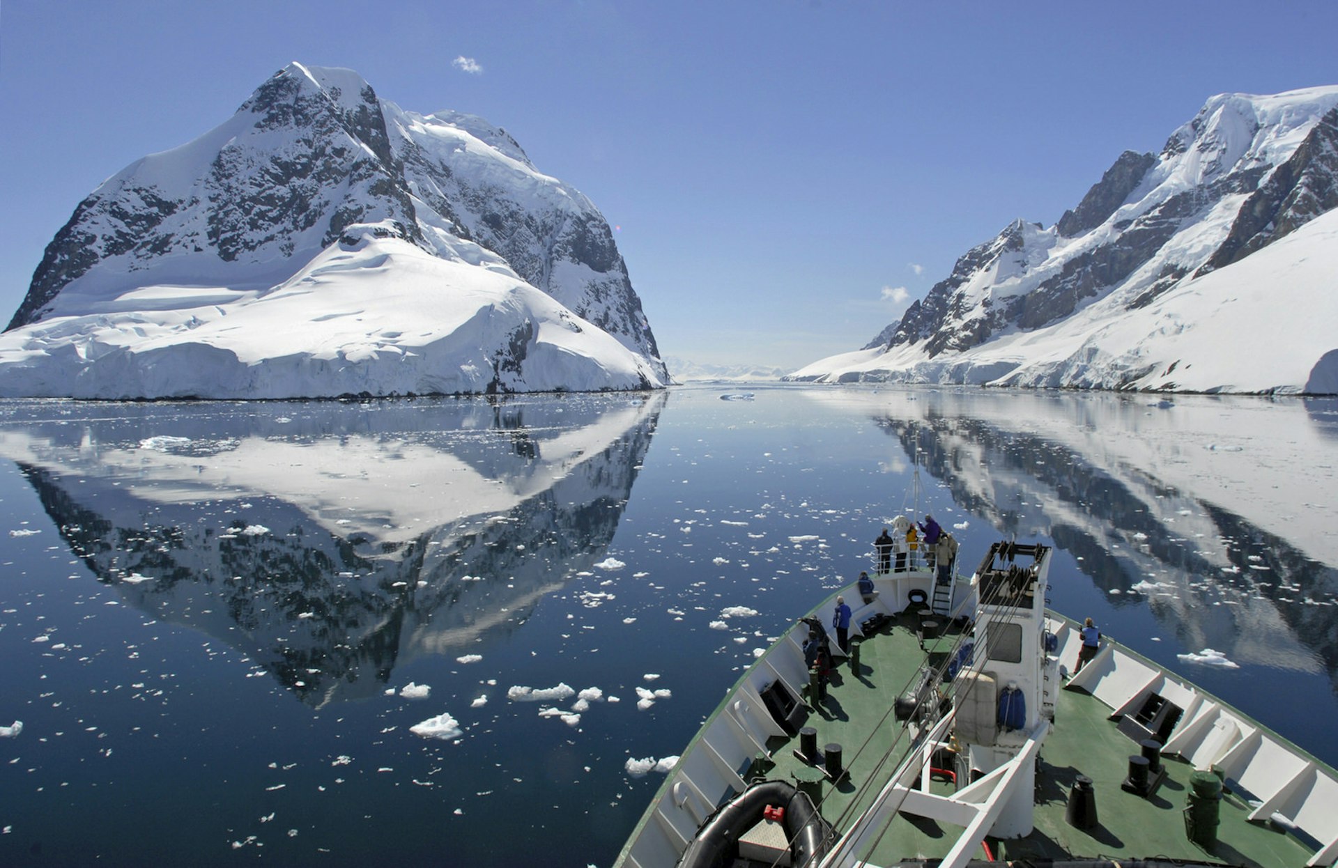 A small cruise ship makes passage through the Lemaire Channel in Antarctica