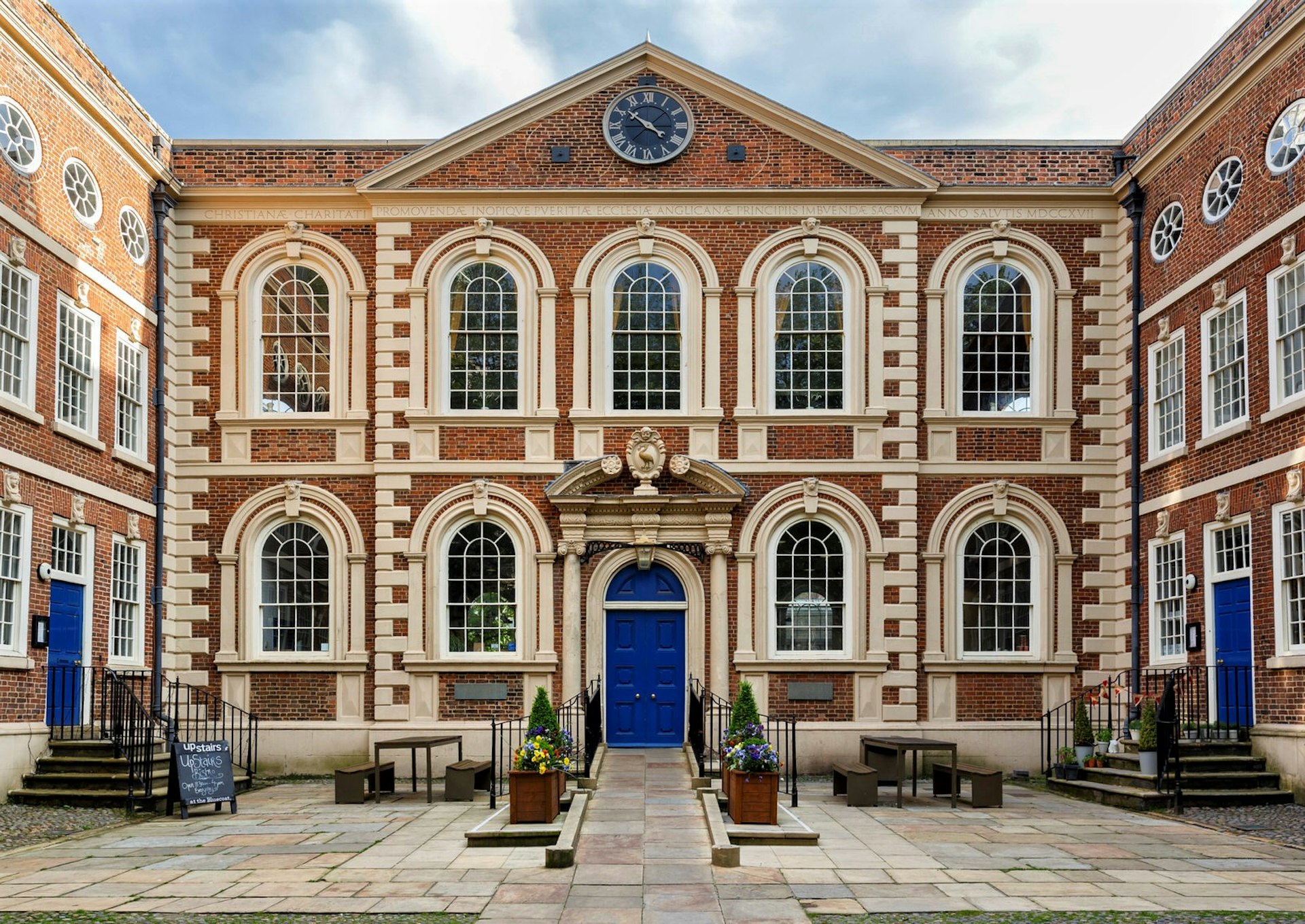 Bluecoat Chambers, Liverpool. The red-brick building has cream highlights and startling blue doors.