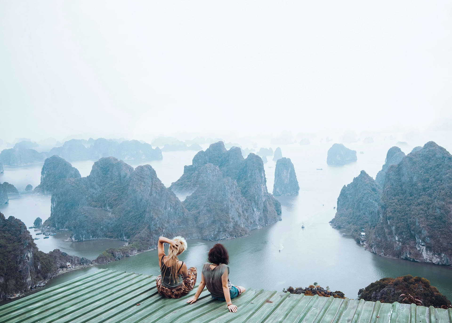 Two women looking down on Halong Bay, Vietnam