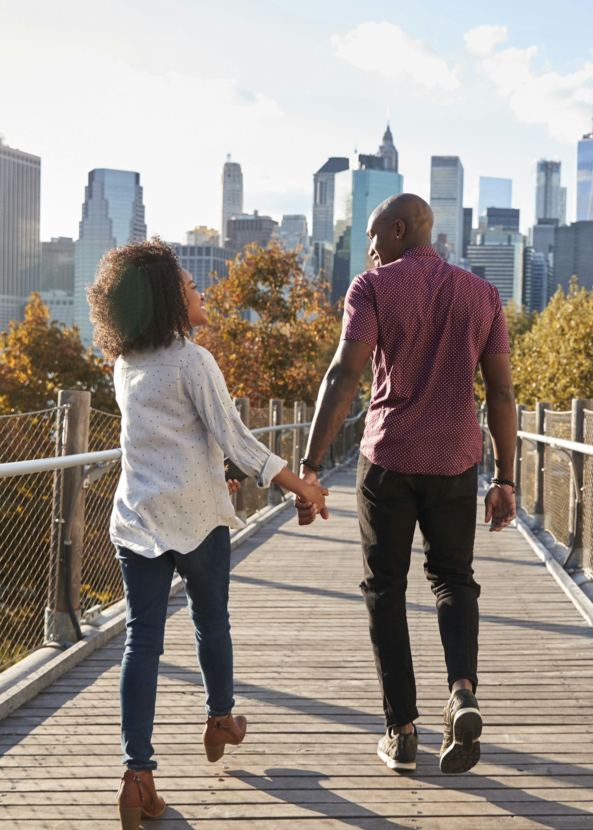 Couple walking with Manhattan skyline in the background