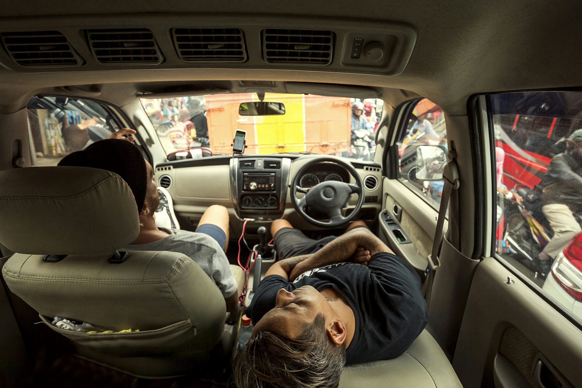 Two men sleeping in a car